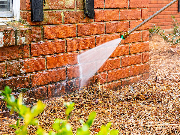 How to Properly Pressure Wash a Brick House Without Damaging It